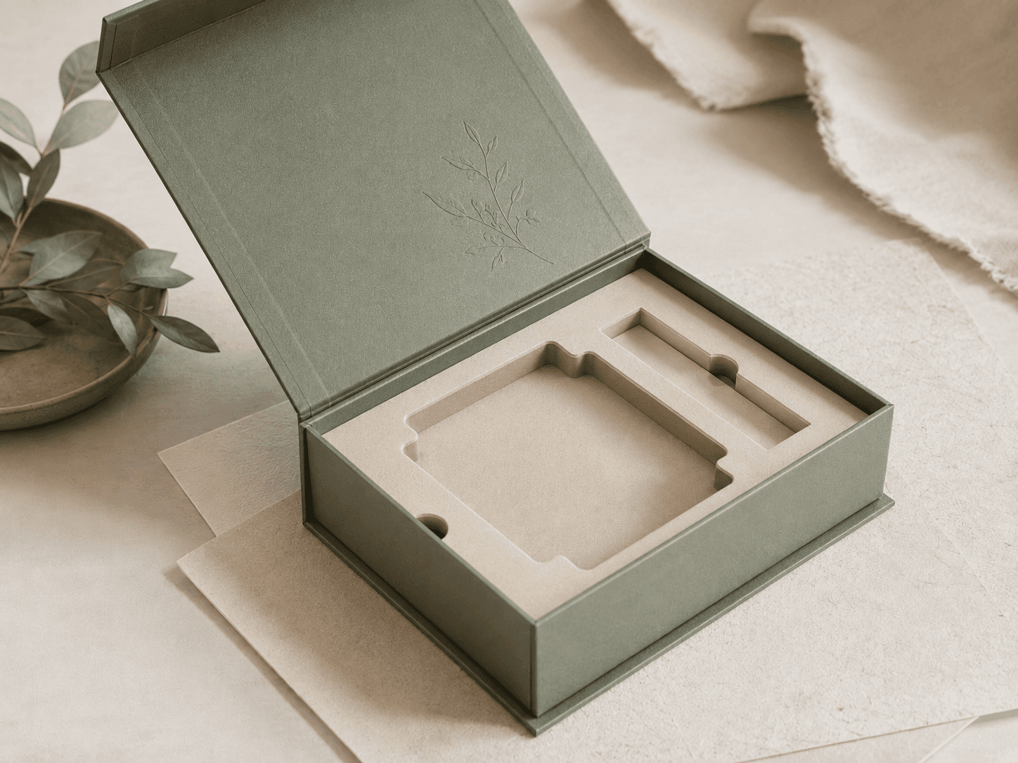 Open sage rigid box revealing a paper-pulp molded cradle insert