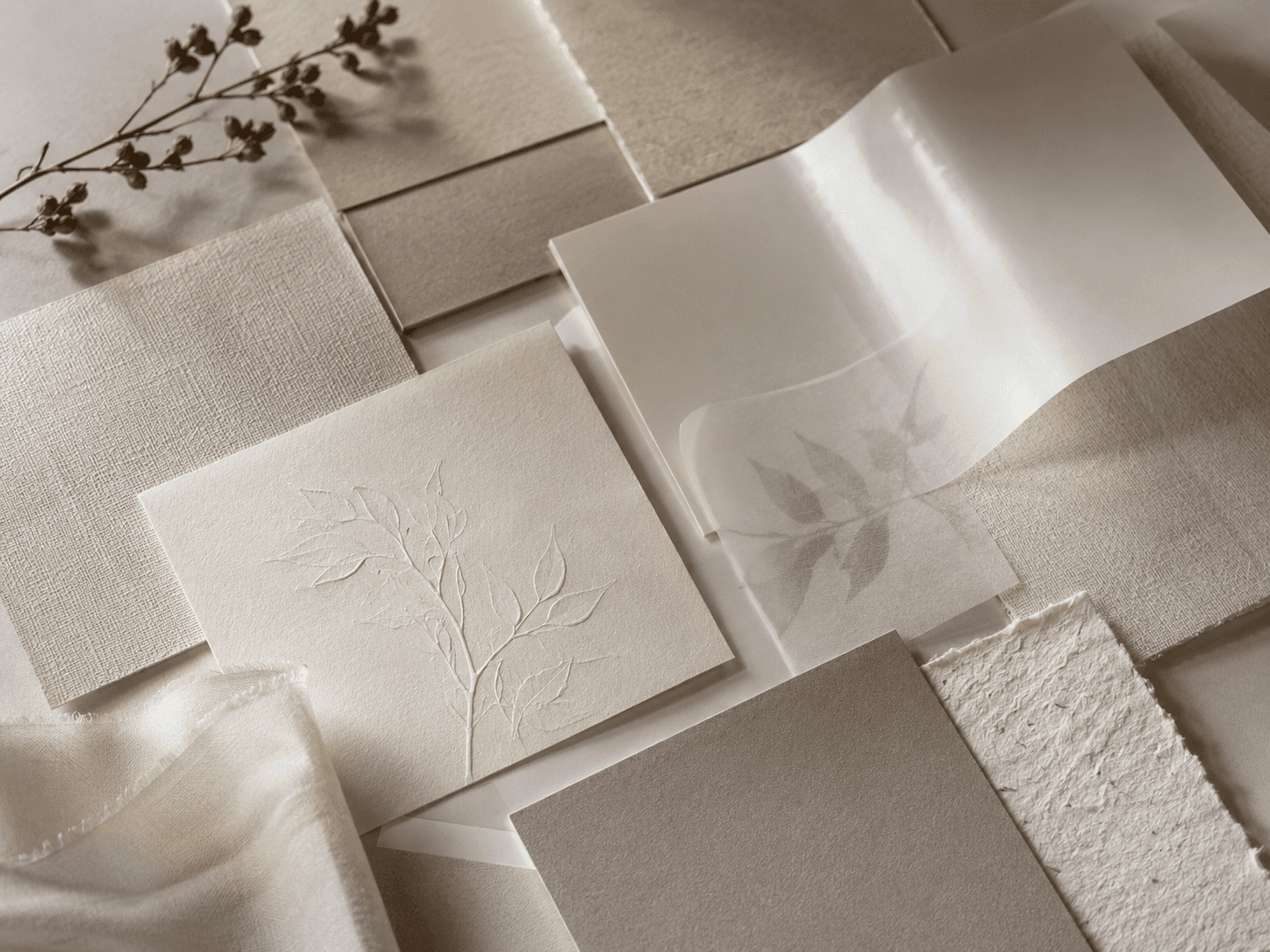 Multiple premium paper textures stacked — matte, soft-touch, sage embossed