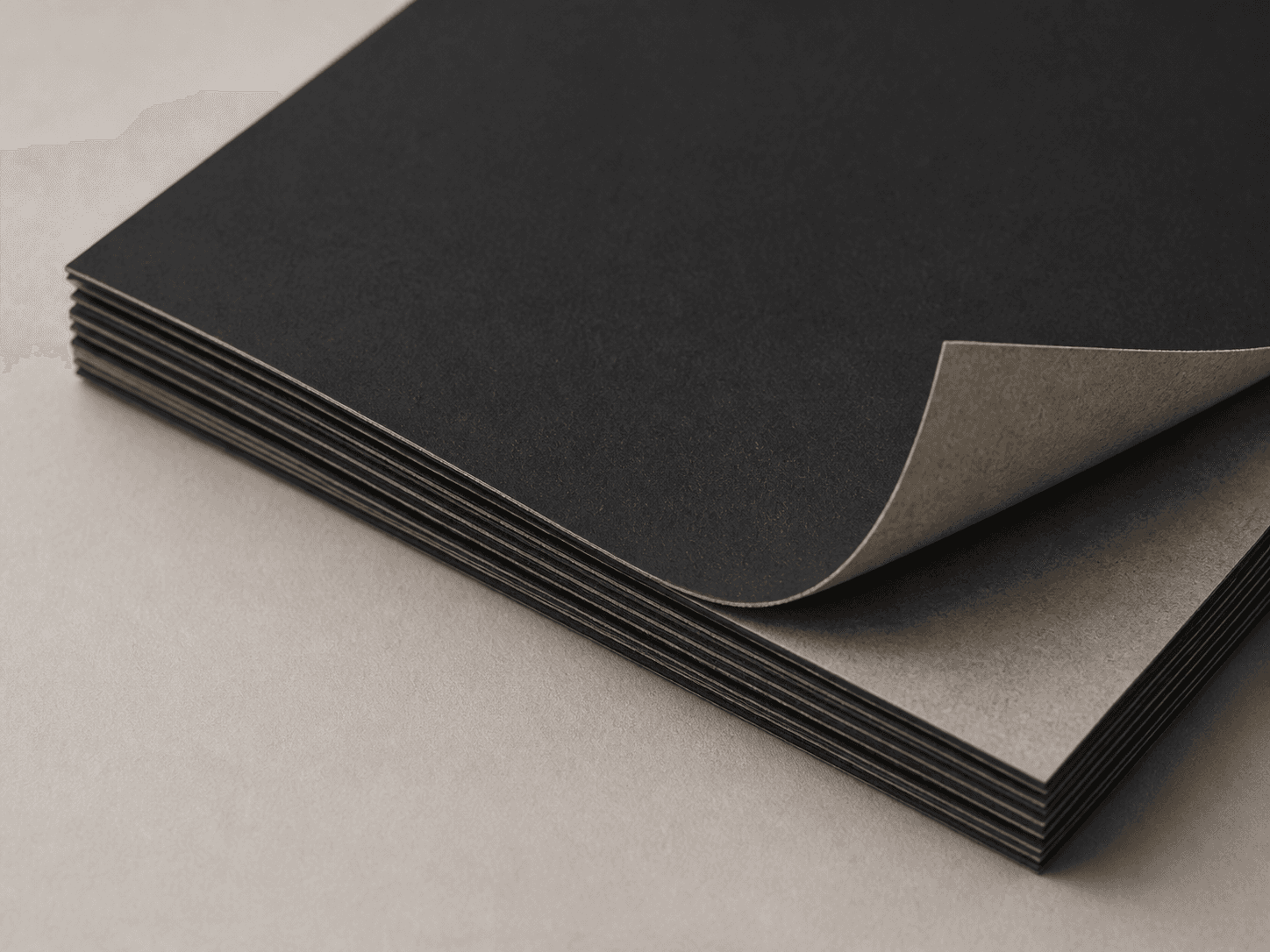 Macro photo of single-black card with a matte black face and gray back