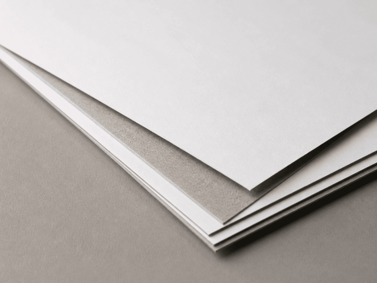 Macro photo of single-white duplex paperboard with a white face and gray back
